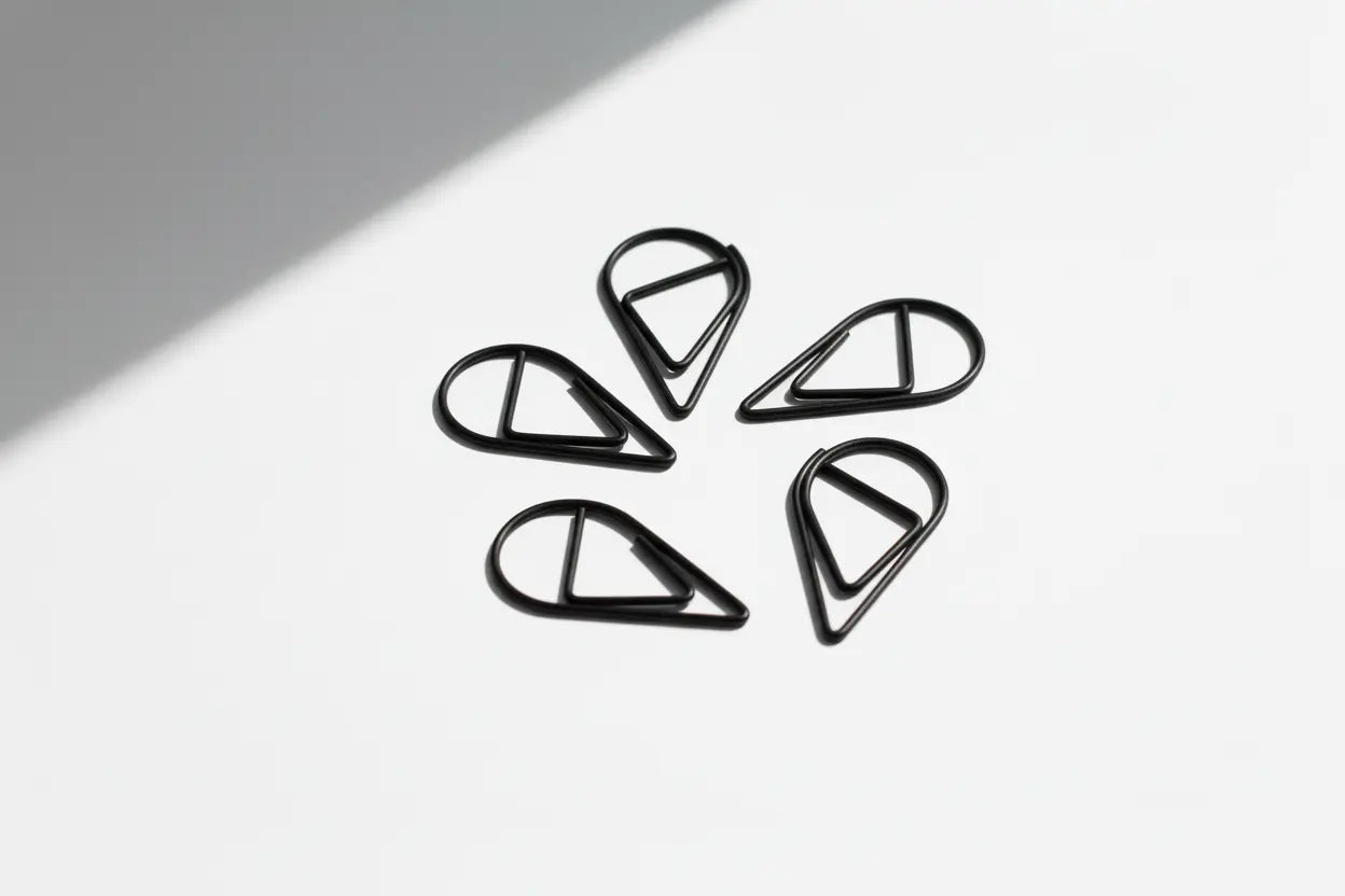 Five black tear drop paperclips