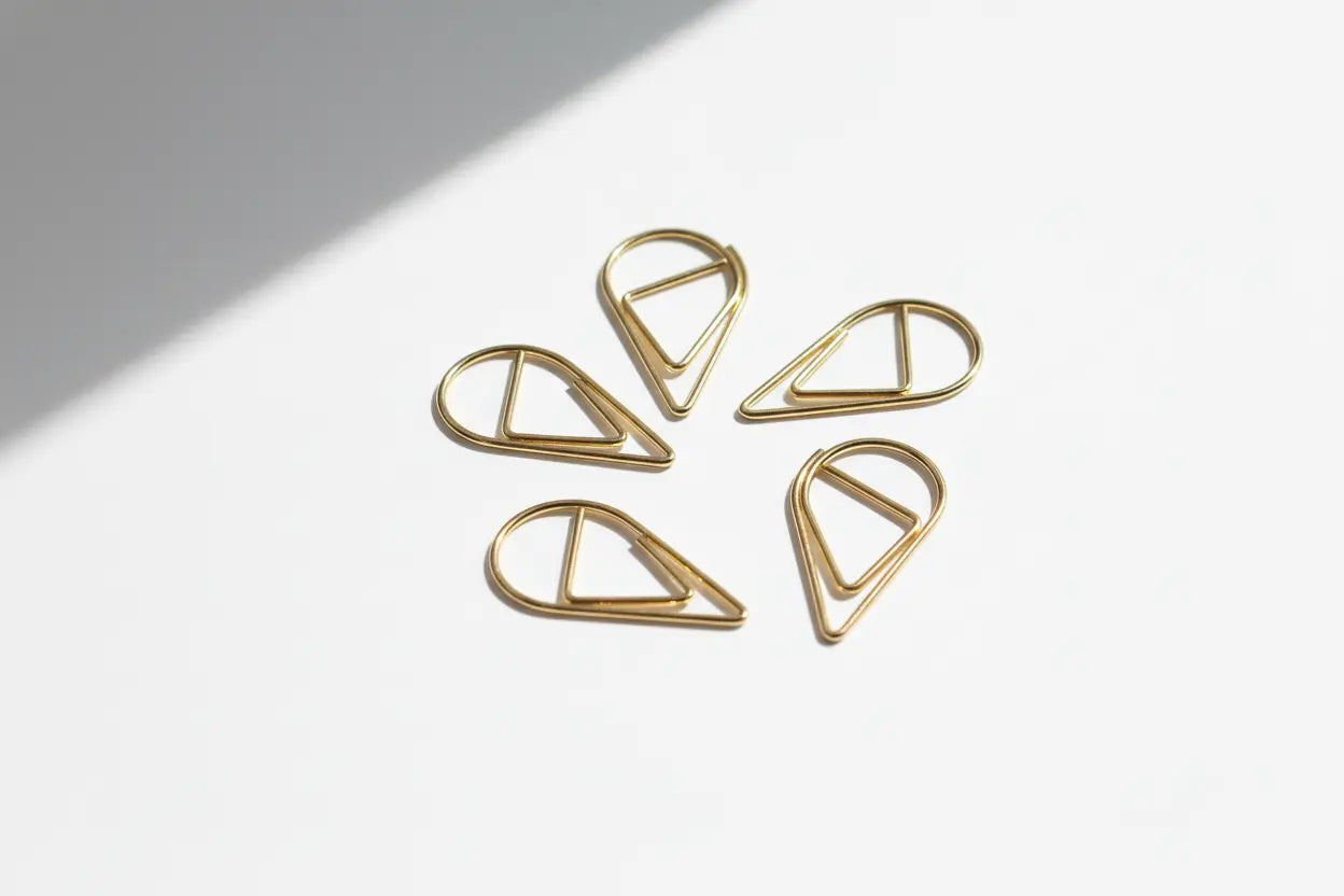 Five gold tear drop paperclips landscape image