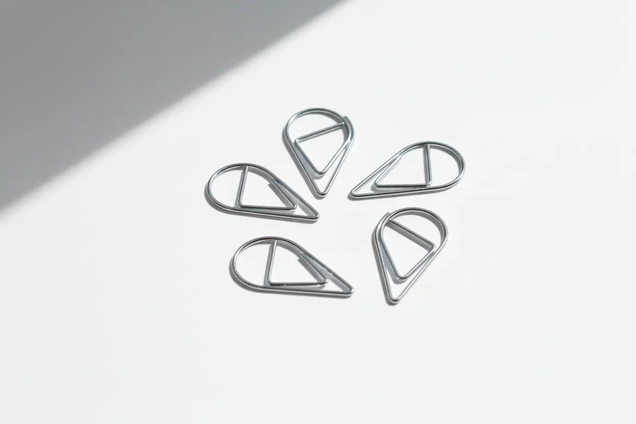 Five silver tear drop paperclips