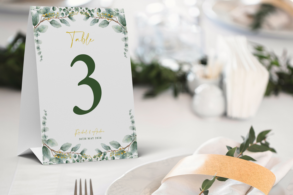 Table number card with greenery design on a table setting